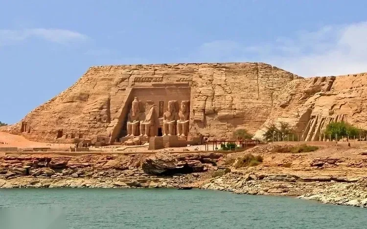 Distant view of the Great Temple of Abu Simbel rising above the shoreline of Lake Nasser.