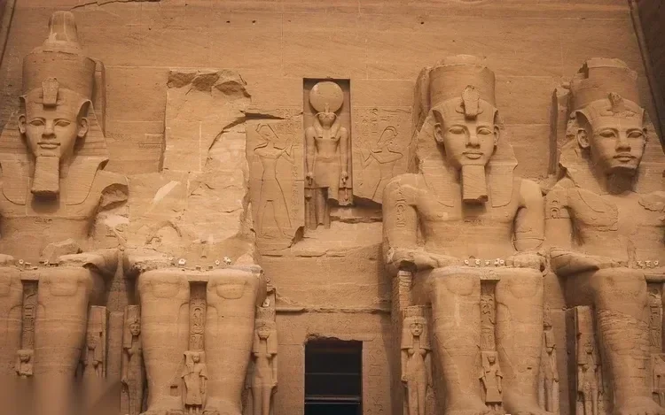 Close-up of two of the seated colossal statues flanking the entrance of the Great Temple
