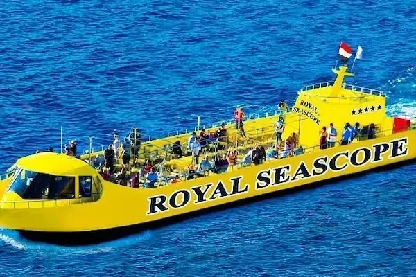 Gelbes Royal-Seascope-Boot mit Fünf-Sterne-Flagge und Passagieren auf dem offenen Oberdeck auf offenem Meer